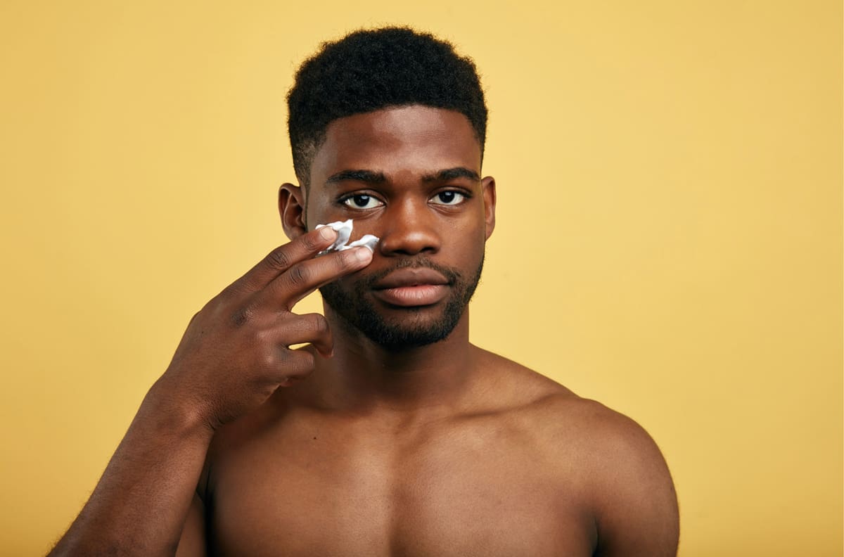 man applying skincare products for a healthy routine